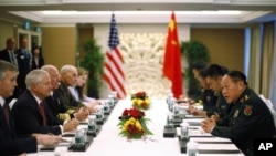 U.S. Secretary of Defense Robert Gates (2nd L) meets China's Defence Minister Liang Guanglie (R) at the 10th International Institute of Strategic Studies (IISS) Asia Security Summit: The Shangri-La Dialogue in Singapore June 3, 2011.