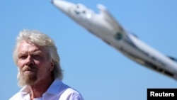 FILE - Richard Branson listens to speeches as he is inducted into the Flight Path Walk of Fame at Los Angeles Airport Flight Path Museum, Los Angeles, March 28, 2018.