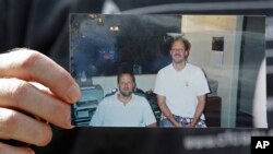 Em trai nghi phạm, ông Eric Paddock cầm tấm ảnh chụp với anh trai Stephen Paddock (bên phải)