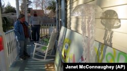 Madeline Fox prepares to decorate her family's yard for Mardi Gras in New Orleans, on Wednesday, Jan. 13, 2021. (AP Photo/Janet McConnaughey)