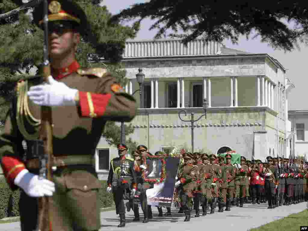 The coffin of Afghan former president Burhanuddin Rabbani who was killed three days ago, is being carried by the guards of honor during his funeral ceremony at the presidential palace in Kabul, Afghanistan, Friday Sept. 23, 2011. Dignitaries on Friday pa