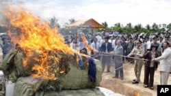 Cambodian officers burn nearly three tones of various drug making substances, which were seized in raids, in early 2009, in eastern and southern Cambodia.