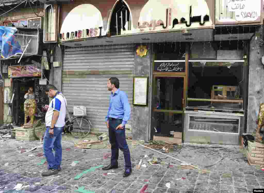 This SANA photo shows the destruction after bombs exploded in al-Marjeh Square in Damascus, June 11, 2013.