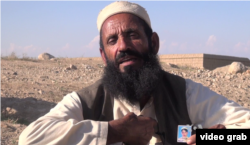 Abdul Malik, the gather of a victim of the Islamic State group's brutality in the Achin district of eastern Afghanistan.