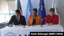From left to right: USAID Administrator Rajiv Shah, UN Emergency Relief Coordinator Valerie Amos and EU Humanitarian Commissioner Kristalina Georgieva sign a "call to action" aimed at averting famine in South Sudan, in Washington on Sat. April 12, 2014.