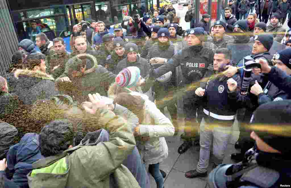 Riot police use pepper spray to disperse demonstrators during a protest against a fire in a dormitory that killed 11 people in the southern city of Adana, in Ankara, Turkey.