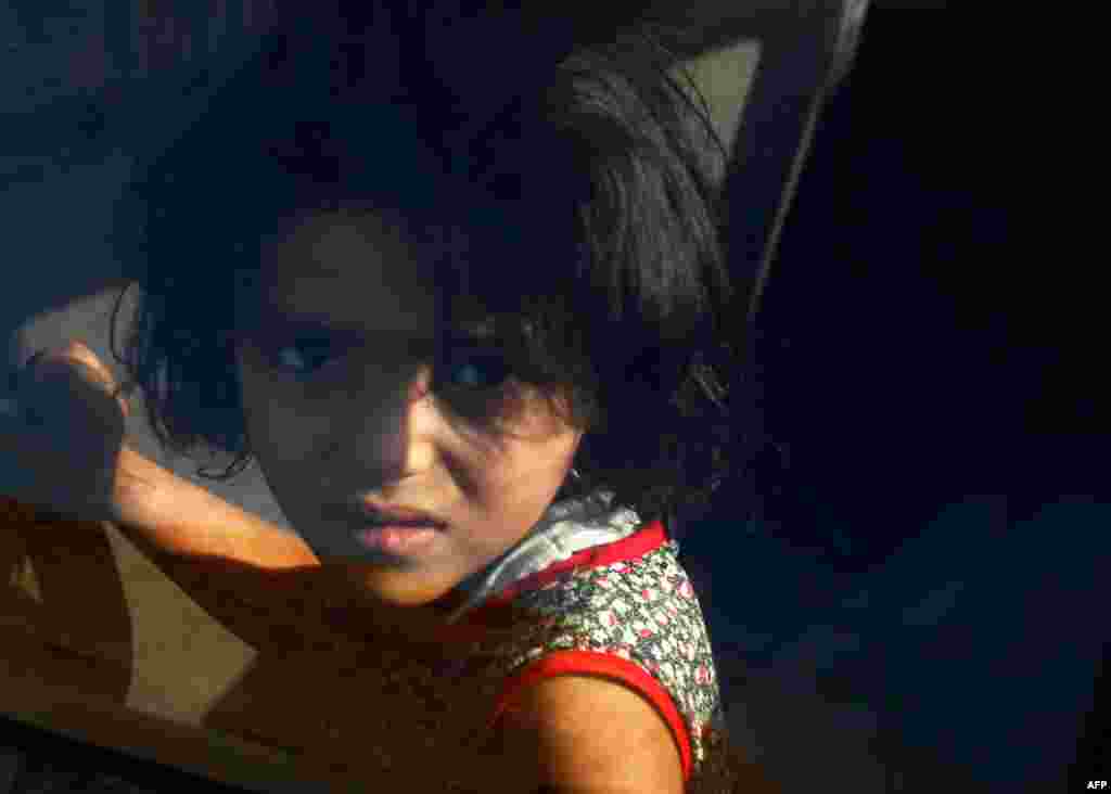 September 14: A Libyan girl is one of a wave of families fleeing the besieged city of Bani Wald, amid escalating violence. REUTERS/Zohra Bensemra