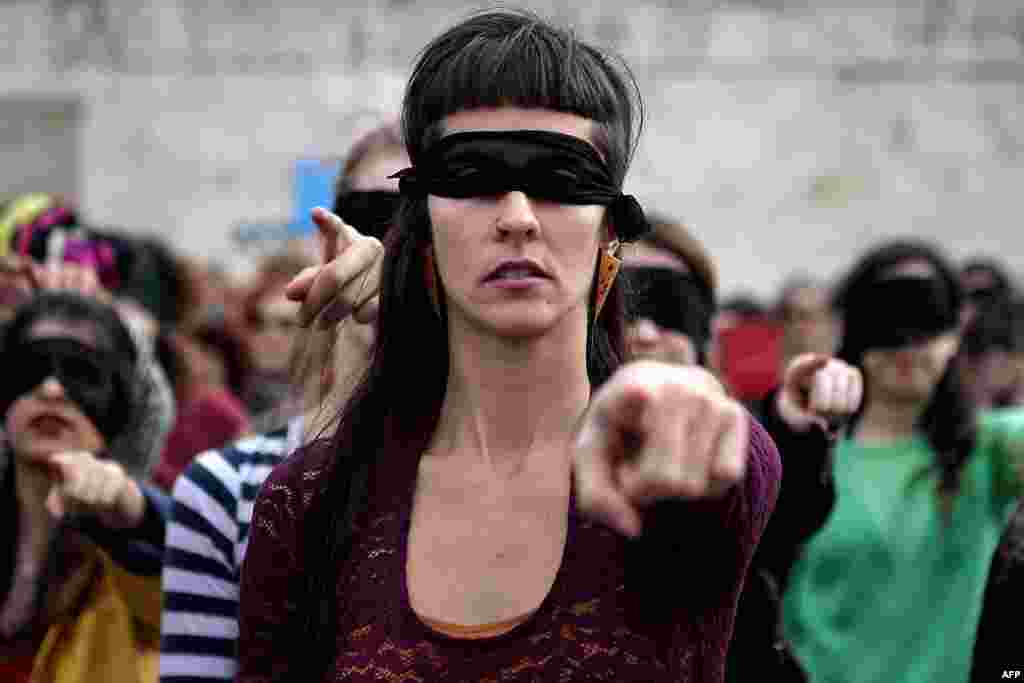 Female activists perform a choreography originated in Chile, and inspired by the Chilean feminist group Las Tesis, to protest against gender violence and patriarchy in front of the Greek parliament at Athens&#39; Syntagma Square, Greece.