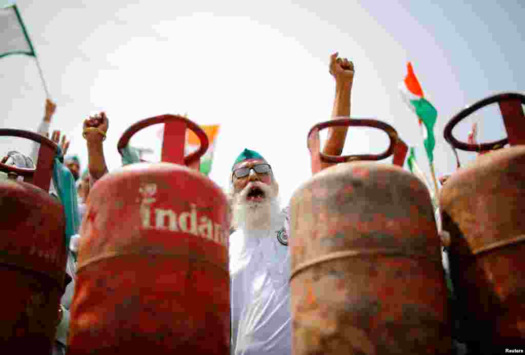 A farmer shouts slogans during a protest against the hike in fuel prices, at the Delhi-Uttar Pradesh border in Ghaziabad, India.
