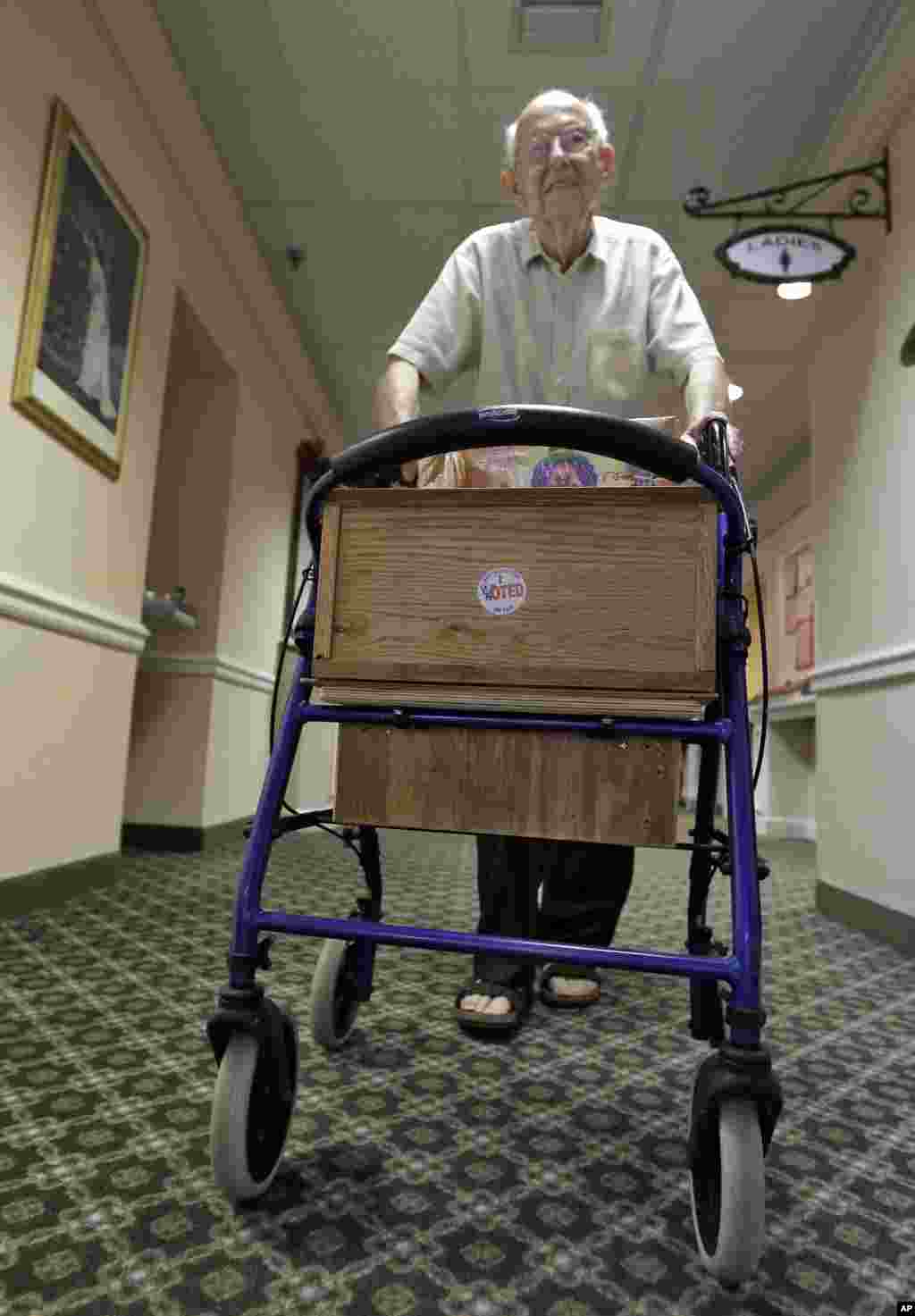 87-year old voter Rolf Kleinwort placed his &quot;I Voted&quot; sticker on the front of his walker as he heads back to his residence at the St. Andrews Estates North retirment community in Boca Raton, Florida.