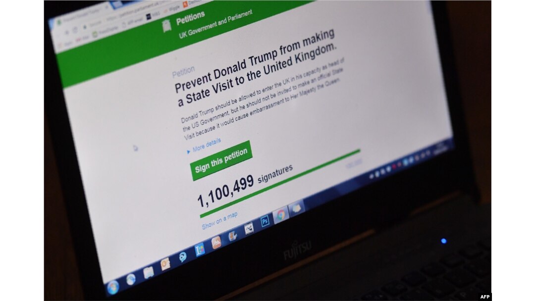 In this posed picture taken in Brenchly, south-east England on January 30, 2017, a laptop screen displays a parliamentary petition on the website of the British government, demanding Britain cancel a planned state visit by U.S. President Donald Trump.