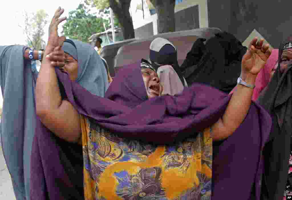 A mother cries after her son was killed in a suicide bomb attack at a military base in Mogadishu, Somalia.