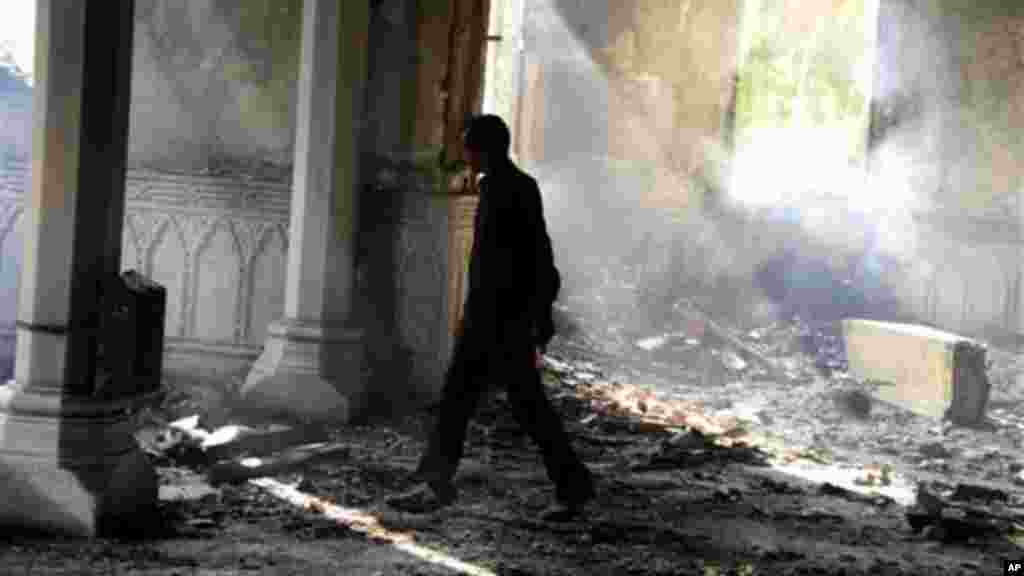 An Egyptian walks among the burned remains of the Rabaah al-Adawiya mosque, Aug. 15, 2013.