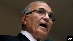 FILE - In this May 26, 2012, photo, Egyptian presidential candidate Ahmed Shafiq speaks to the media during a press conference at his office in Cairo, Egypt. 