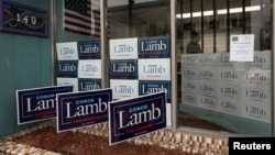Signs adorn the entrance to Congressional candidate Conor Lamb's headquarters at 149 East High Street in Waynesburg, Pennsylvania, Feb. 14, 2018.