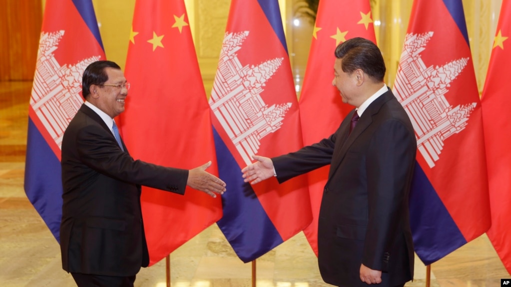 FILE: Cambodian Prime Minister Hun Sen, left, shakes hands with China's President Xi Jinping before a meeting at the Great Hall of the People in Beijing Friday, Nov. 7, 2014. (AP Photo/Jason Lee, Pool)