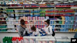 FILE - Women shop at a supermarket in Buenos Aires, Argentina, Oct. 18, 2021. 