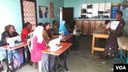 Students attend a sewing class at the Refuge and Hope International School in Kampala, Uganda, where Isidoro Magda trained. (Simon Peter Apiku/VOA)