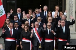 FILE - Peru's President Pedro Pablo Kuczynski (C) poses with newly sworn-in ministers after a ceremony at the government palace in Lima, Sept. 17, 2017.