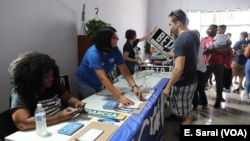 Local organizations set up tables to register people to vote at a Beto O'Rourke rally.