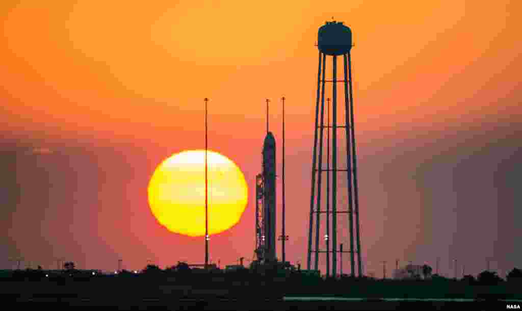 The Orbital Sciences Corporation Antares rocket, with the Cygnus spacecraft onboard, is seen on launch Pad-0A during sunrise at NASA's Wallops Flight Facility in Virginia. The Antares will launch with the Cygnus spacecraft filled with over 5,000 pounds of supplies for the International Space Station, including science experiments, experiment hardware, spare parts, and crew provisions. 