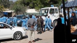 Somali police cadets arrive to help carry away the dead and injured following a suicide bomb attack on a police academy in the capital Mogadishu, Somalia, Dec. 14, 2017.