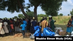 People in the town of Koch, in South Sudan's Unity state, are given tents for temporary shelter on Sept. 25, 2015, when the World Food Program and UNICEF resumed aid deliveries to the area after a four-month break.