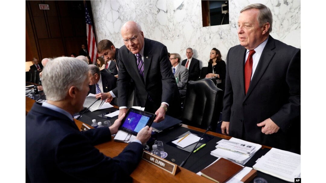 Sen. Richard Durbin, D-Ill., right, and Sen. Patrick Leahy, D-Vt., center, speak with Supreme Court Justice nominee Neil Gorsuch, left, on Capitol Hill in Washington, March 21, 2017.