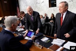 Sen. Richard Durbin, D-Ill., right, and Sen. Patrick Leahy, D-Vt., center, speak with Supreme Court Justice nominee Neil Gorsuch, left, on Capitol Hill in Washington, March 21, 2017, before the start of his confirmation hearing before the Senate Judiciary Committee.