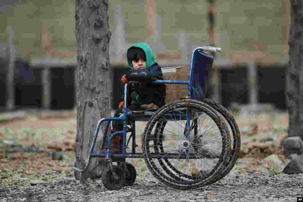A Syrian child sits on a wheelchair after he and the family crossed into Turkey, in the Oncupinar border crossing with Syria, known as Bab al Salameh in Arabic, in the outskirts of the town of Kilis, Turkey.