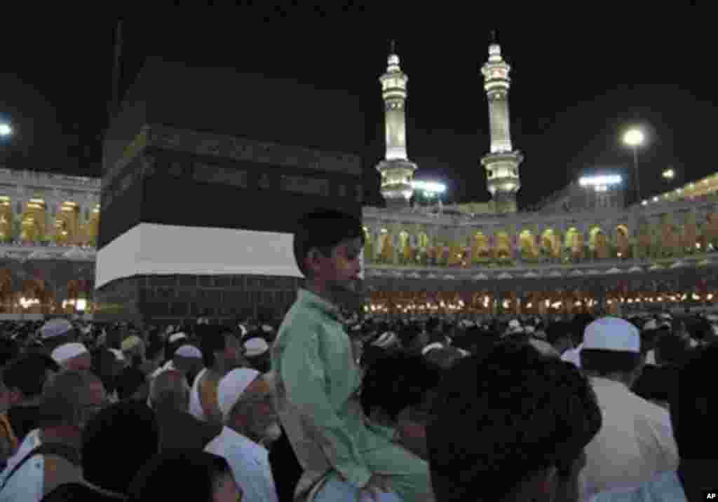 Muslim pilgrims moving around the Kaaba, the black cube seen at center, inside the Grand Mosque, during the annual Hajj in Mecca, Saudi Arabia, Saturday, Nov. 13, 2010.