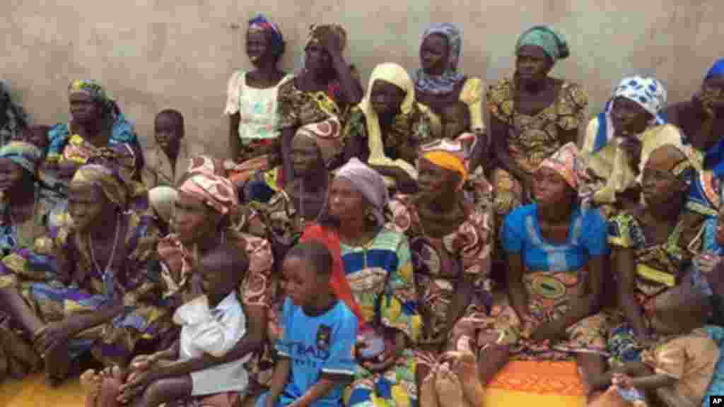 Women and children who survived attacks by Boko haram sits outside a compound at St. Paul's Roman Catholic Church, in Wada Chakawa, Yola, Nigeria. Before the usher could finish warning worshippers of the gunmen approaching, the attackers were storming in