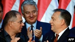 Hungarian PM Viktor Orban (R) celebrates with his party leader of their governing FIDESZ party, vice-president Lajos Kosa (L) and deputy prime minister Zsolt Semjén of the Christian Democratic People's Party in Budapest, Oct. 2, 2016.