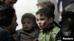 Injured children rest in a field hospital in the Duma neighborhood of Damascus, Jan. 21, 2015.
