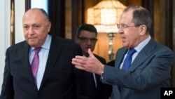 Russian Foreign Minister Sergey Lavrov, right, and his Egyptian counterpart Sameh Shukry arrive for their meeting in Moscow, Russia, Wednesday, March 16, 2016.