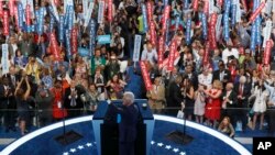 Former President Bill Clinton waves to delegates.