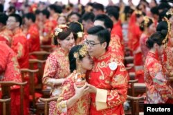 Alibaba employees attend a mass wedding at their headquarters in Hangzhou, Zhejiang province, May 10, 2017.