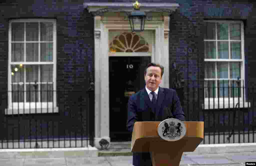 Britain's Prime Minister David Cameron speaks to members of the media in front of 10 Downing Street in London, Sept. 19, 2014.