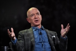 FILE - Amazon founder Jeff Bezos addresses the audience at the Amazon Re:MARS conference on robotics and artificial intelligence at the Aria Hotel in Las Vegas, Nevada on June 6, 2019. (Photo by Mark RALSTON / AFP)