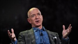 FILE - Amazon founder Jeff Bezos addresses the audience at the Amazon Re:MARS conference on robotics and artificial intelligence at the Aria Hotel in Las Vegas, Nevada on June 6, 2019. (Photo by Mark RALSTON / AFP)