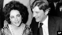 Actress Elizabeth Taylor and her husband, former secretary of the U.S. Navy John Warner, at the 42nd New York Film Critics Circle Awards dinner in New York, Jan. 30, 1977