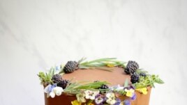 Baker, food stylist and photographer Lauren Cooper Allen uses edible flowers, such as violets, on her cakes and other baked treats. In this photo, she used pansies on a birthday cake.(Photo by Lauren Cooper Allen)