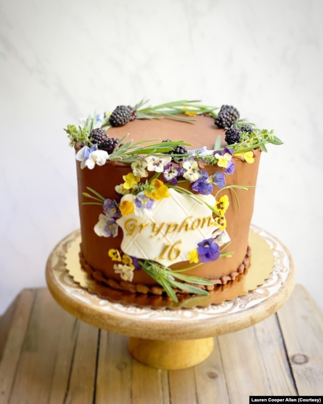 Baker, food stylist and photographer Lauren Cooper Allen uses edible flowers, such as violets, on her cakes and other baked treats. In this photo, she used pansies on a birthday cake.(Photo by Lauren Cooper Allen)