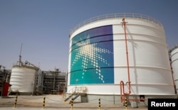 FILE - An Aramco oil tank is seen at the production facility at Saudi Aramco's Shaybah oilfield in the Empty Quarter, Saudi Arabia, May 22, 2018.