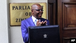 Zimbabwe's Finance Minister Tendai Biti arrives to deliver his budget speech in parliament in Harare, November 24, 2011.
