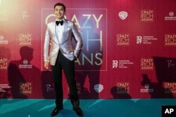 Actor Henry Golding poses as he arrives for the red carpet screening of the movie "Crazy Rich Asians," Aug. 21, 2018, in Singapore.