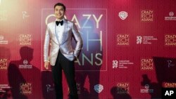 Actor Henry Golding poses as he arrives for the red carpet screening of the movie "Crazy Rich Asians," Aug. 21, 2018, in Singapore.