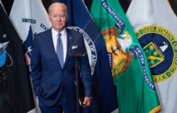 Joe Biden leaves after addressing the Intelligence Community