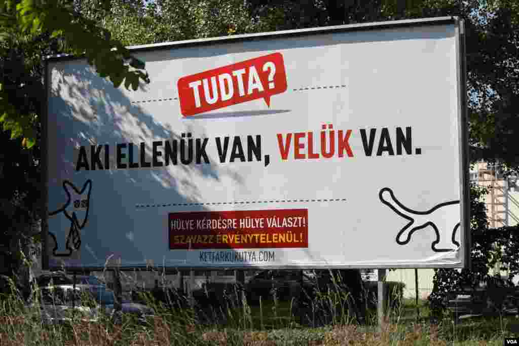 This billboard, by the jokester “Two-Tailed Dog Party” mocks government slogans, finishing with their call to their supporters, saying, “For stupid questions, give stupid answers,” Budapest, Sept. 20, 2016. (VOA/H. Murdock) 