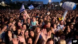 In this Monday, May 14, 2018 photo, Israelis watch Israeli Singer Netta Barzilai who won the 2018 Eurovision song contest as she performs at Rabin square in Tel Aviv, Israel. (AP Photo)
